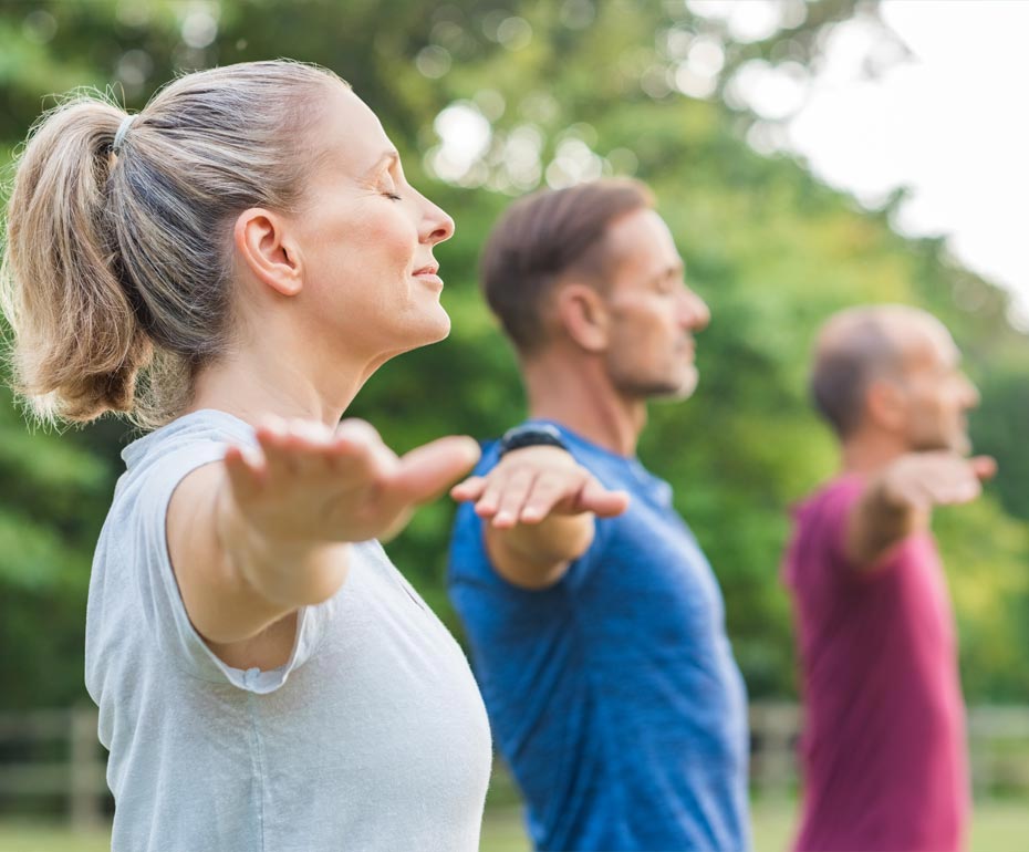 three people doing yoga